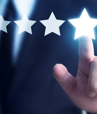 Businessman hand touching five star symbol to increase rating of company concept, Copy space background for your title